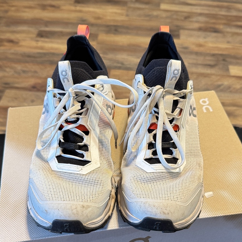 On Running White and Black Athletic Shoes